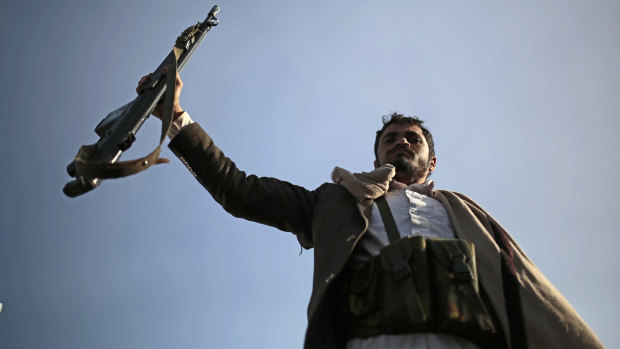 A Houthi supporter holds his weapon during a demonstration against the United States over its decision to designate the Houthis a foreign terrorist organisation in Sanaa, Yemen, on Monday.