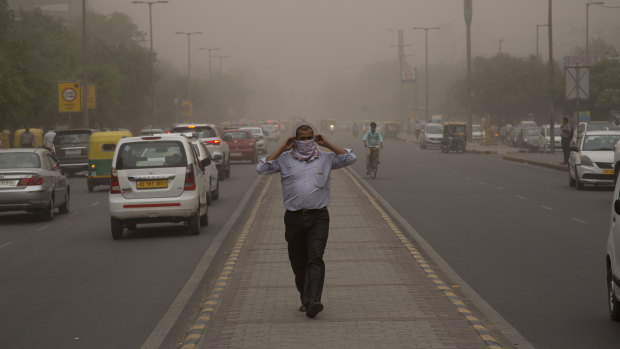 A dust storm envelops the city in New Delhi after a powerful rain storm swept parts of north and western India.