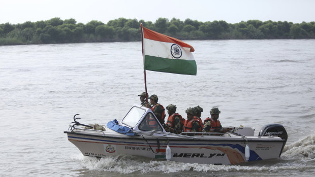 Indian border forces patrol Chenab river along the India-Pakistan border in Akhnoor.