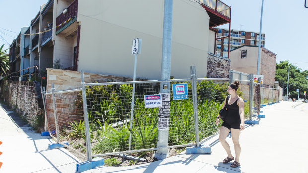 A site at Rozelle is fenced off after asbestos was found in the garden bed.