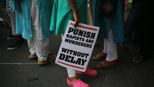 A protester stands with a placard during a rally against sexual violence in New Delhi earlier this year.