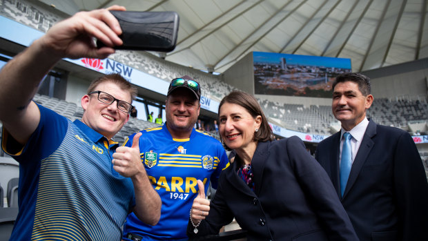 NSW Premier Gladys Berejiklian and Skills Minister and member for Parramatta Geoff Lee pose for a selfie with supporters at the Bankwest Stadium Open Day on Sunday.