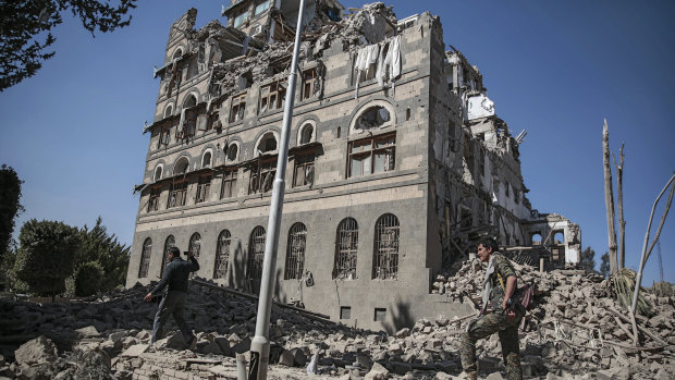 Houthi Shiite rebels inspect the rubble of the Republican Palace that was destroyed by Saudi-led airstrikes in Sanaa, Yemen in December last year.