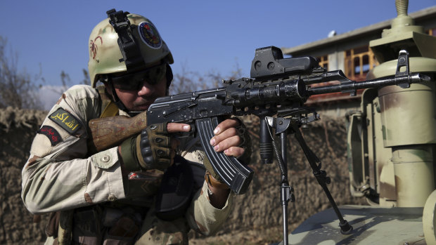 Security personnel take position near the site of an attack near the Bagram Air Base in Afghanistan. 