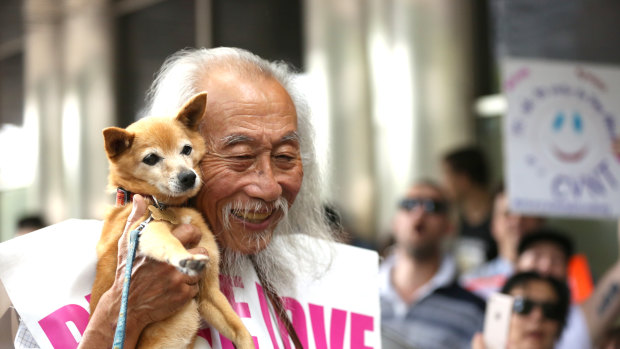 Danny Lim attending a protest over his January 11 arrest with his dog Smarty.