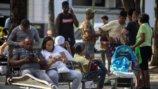 People surf the internet at a government-sponsored Wi-Fi spot at a park in Havana. They will now be able to have internet on the go. 
