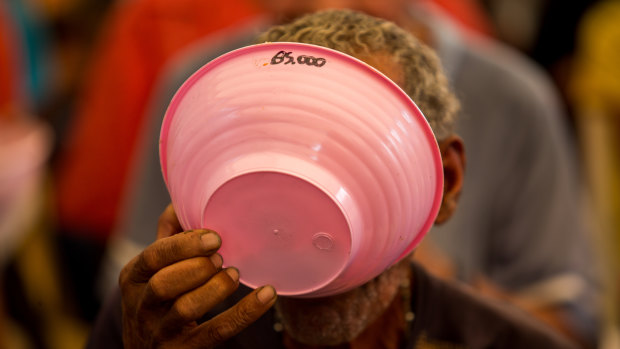 A resident eats free soup at a political rally in Vargas state, Venezuela last week.