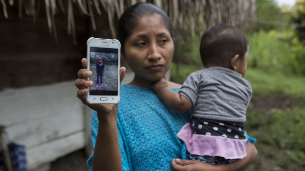 Claudia Maquin, 27, shows a photo of her daughter, Jakelin. The 7-year-old girl died in a Texas hospital, two days after being taken into custody by border patrol agents.