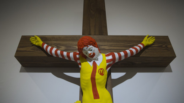 An artwork called McJesus, which was sculpted by Finnish artist Jani Leinonen and depicts a crucified Ronald McDonald, is seen on display as part of the Haifa museum's "Sacred Goods" exhibit.