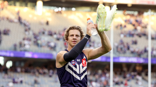 Fill your boots: Nat Fyfe salutes the crowd at Optus Stadium after the Dockers' round 1 thrashing of the Roos.