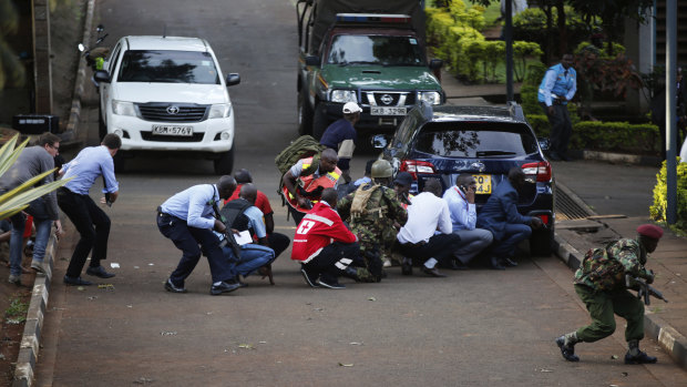 People take cover after an attack on a hotel in Nairobi on Tuesday.