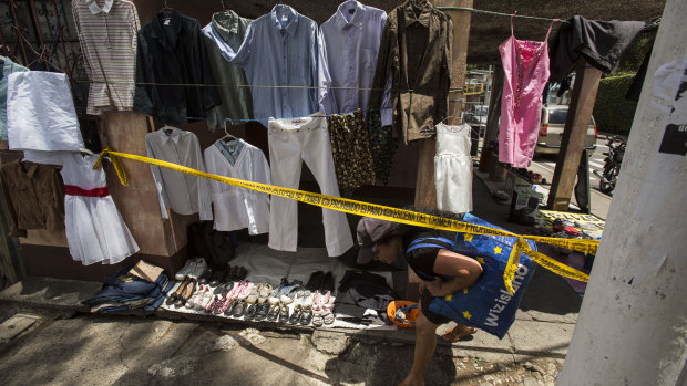 A woman enters a crime scene in Guatemala city. According to the US Homeland Security hunger, not violence, is driving migration from Guatemala to the United States. 