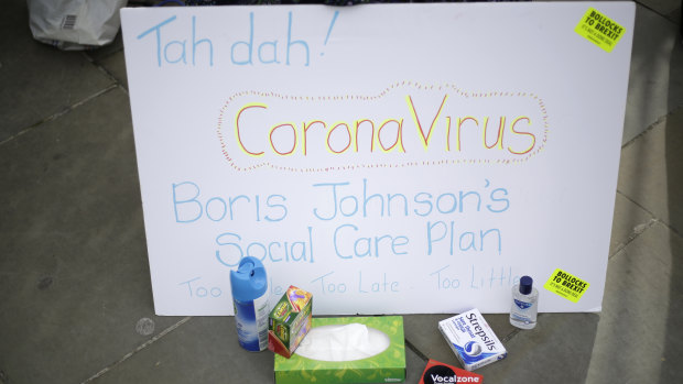 Anti-Brexit campaigners hold placards including references to the outbreak of coronavirus as they protest outside Parliament in London on Wednesday.