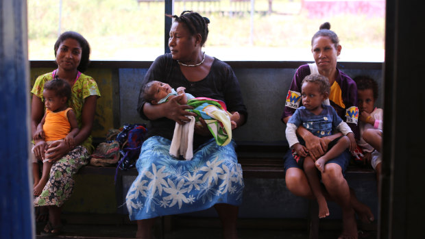Women wait to have their children vaccinated at the Waima sub-health centre in Papua New Guinea. 