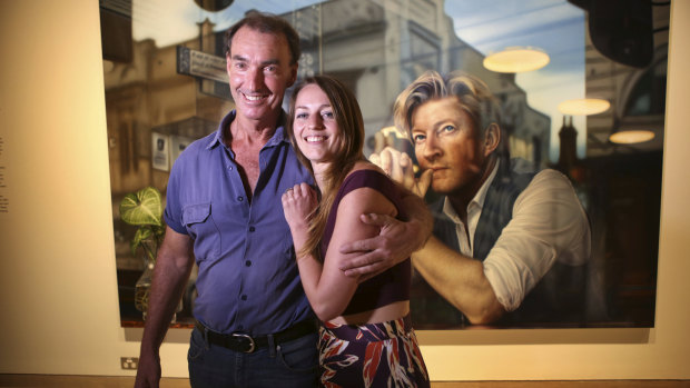 Winner of the 2019 Archibald Packing Room Prize Artist Tessa MacKay with head packer Brett Cuthbertson in front of her painting of actor David Wenham at the Art Gallery of NSW.