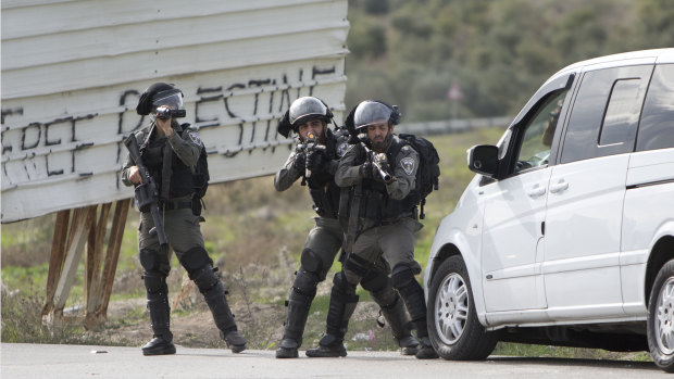 Israeli security forces take position during clashes with Palestinians after a demonstration against the arrest of members of Fatah in Jerusalem by the Israeli authorities, in the West Bank on Sunday.