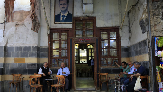 Syrians smoke water pipes at a coffee shop at the Hamidiyeh market, in the Old City of Damascus, Syria, on Sunday.