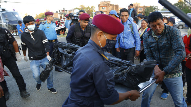 Officials unload the bodies in Kathmandu.