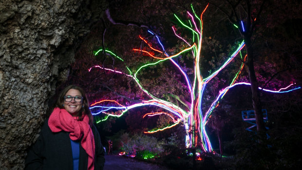 Royal Botanic Gardens creative producer Kara Ward in front of the neon tree installation.
