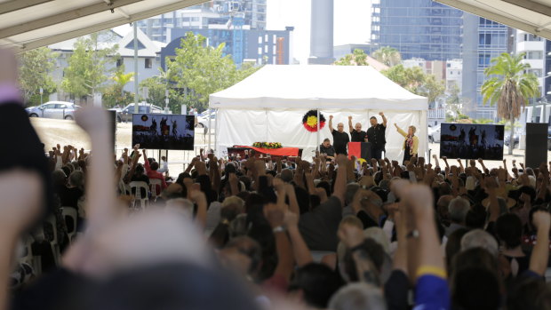 Mourners with fists upraised paid tribute to a giant of the Brisbane community.