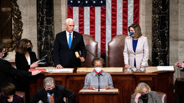 US Vice-President Mike Pence and US House Speaker Nancy Pelosi lead the joint sitting of Congress. Joe Biden's election win was finally certified at 3.33am local time.