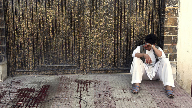 A relative of a victim cries outside the voter registration centre that was attacked.