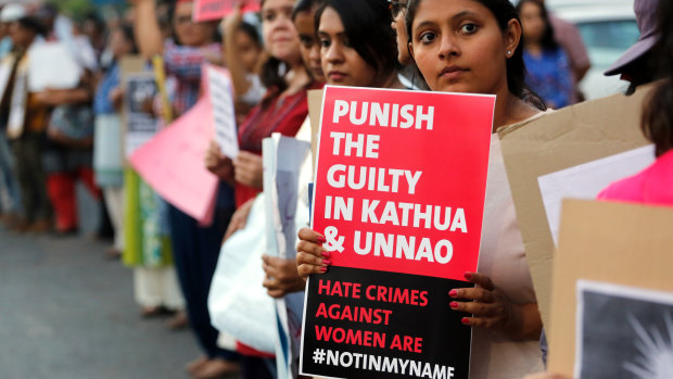 An Indian girl holds a placard during a protest against two recently reported rape cases, on Wednesday.
