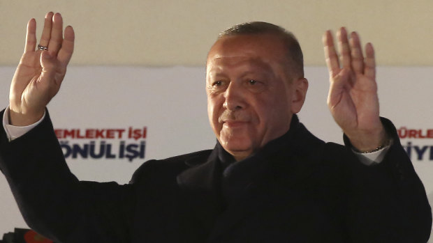 Turkey's President and ruling Justice and Development Party leader, Recep Tayyip Erdogan, greets supporters after the results of the local elections were announced in Ankara, Turkey, early on Monday, April 1.