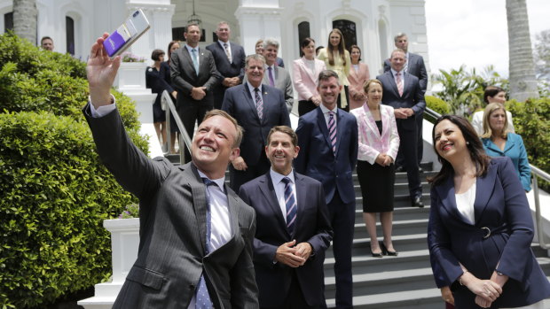 Deputy Premier Steven Miles wrangles his newly sworn-in cabinet colleagues for a selfie at Government House.