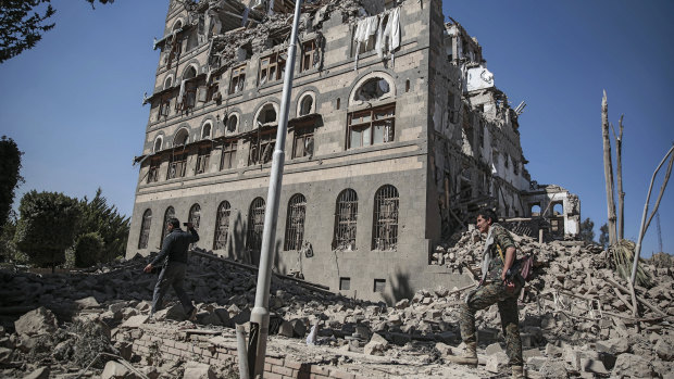 Houthi Shiite rebels inspect the rubble of the Republican Palace that was destroyed by Saudi-led airstrikes, in Sanaa, Yemen, in December last year.