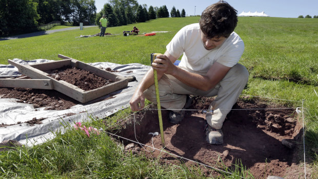 Dig this: Paul Brown, of the Public Archaeology Facility at Binghamton University, measures a dig at the site of the original Woodstock Music and Art Fair, in Bethel, New York.