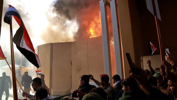 Protesters break into the US embassy compound, in Baghdad, Iraq, on Tuesday.