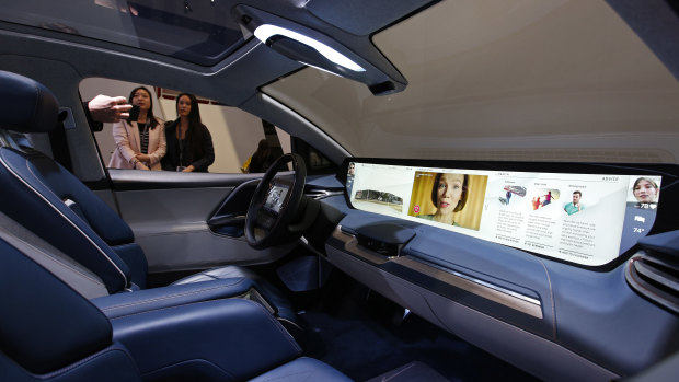 The interior of the Byton M-Byte SUV has a massive dash display, plus screens on the steering wheel and the rear of the headrests.