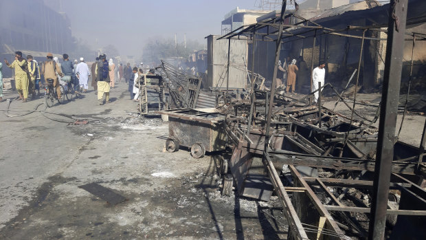 Afghans inspect damaged shops after fighting between Taliban and Afghan security forces in Kunduz city, northern Afghanistan.