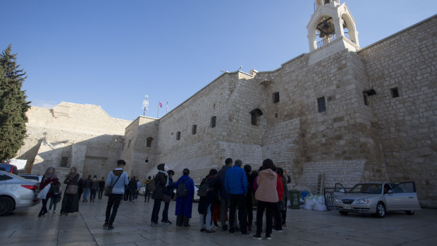 Christian visitors gather outside the Church of the Nativity, traditionally believed by Christians to be the birthplace of Jesus Christ, in the West Bank city of Bethlehem. 