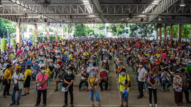 Hundreds of unemployed people wait to apply for government financial aid in Bangkok, Thailand.