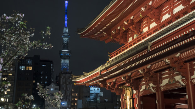The Tokyo Skytree, photographed from Sensoji Temple, is lit in blue to show support for healthcare workers and first responders on the front lines of the coronavirus pandemic