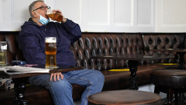 People drink beer in a Liverpool city centre pub ahead of the lockdown closure of bars, gyms and clubs in Liverpool, England. 