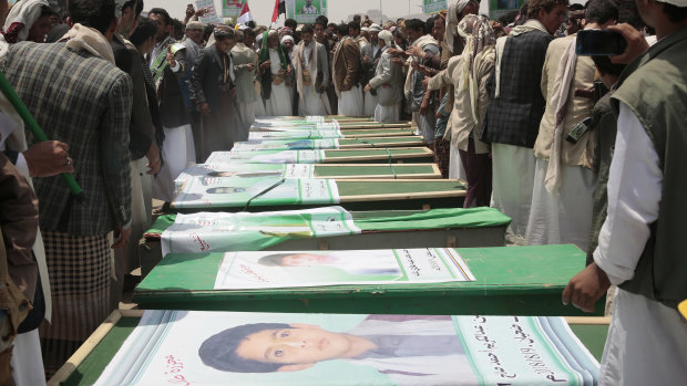 Yemeni people attend the funeral of victims of a Saudi-led airstrike, in Saada, Yemen.