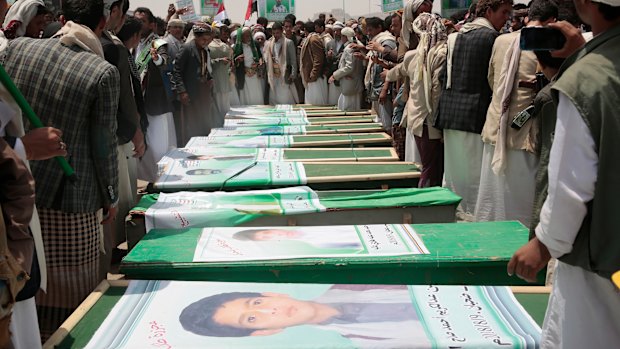 Yemeni people attend the funeral of victims of a Saudi-led airstrike, in Saada, Yemen.