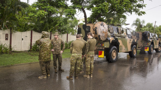Army personnel assisting with flood evacuations in Rosslea, Townsville, on Saturday.