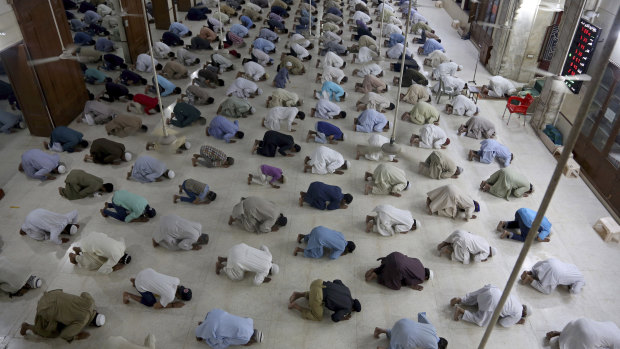 People attend evening prayers while maintaining a level of social distancing to help avoid the spread of the coronavirus, at a mosque in Karachi, Pakistan.
