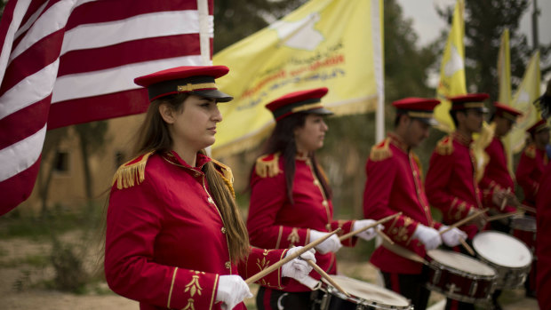 A military band performs ahead of a ceremony at al-Omar Oil Field marking the US-backed Syrian Democratic Forces (SDF) capture of Baghouz, Syria, after months of fighting to oust Islamic State militants on Saturday.