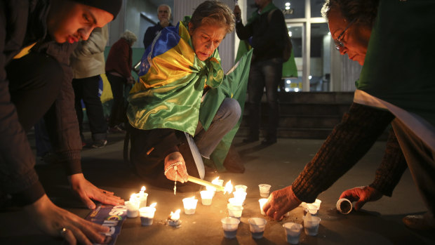 People light candles in support of Jair Bolsonaro, Brazil's Presidential candidate, who was stabbed during a campaign event, in Sao Paulo, Brazil.