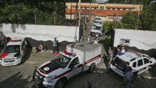 Forensic vehicles transport the bodies of victims of the Raul Brasil State School attack in Suzano, in the greater Sao Paulo, Brazil, on Wednesday.
