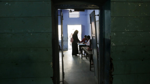 A woman casts her vote at a polling station in Varanasi, India on Sunday