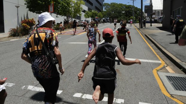 Children run up Russell street as the protest march winds up.