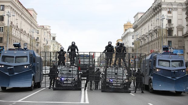 A police barricade with two water cannons is set blocking a street during an opposition rally to protest the official presidential election results in Minsk, Belarus.