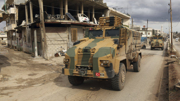 A Turkish military convoy drives through the village of Binnish, Idlib.