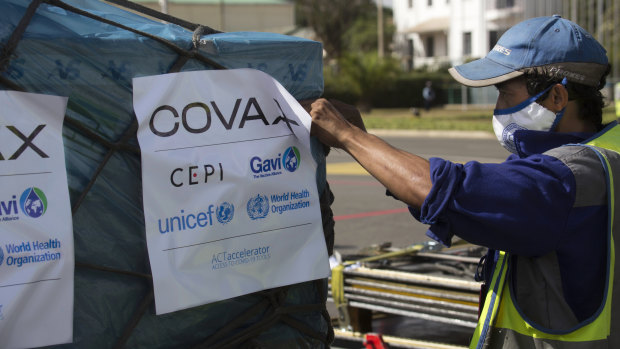 Airport workers spray the cargo of Covax COVID-19 vaccines on arrival in Antananarivo, Madagascar.